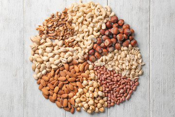 Composition with different nuts on wooden background