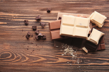 Different kinds of chocolate on wooden table