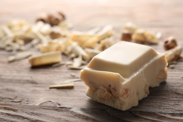 Piece of white chocolate on wooden table