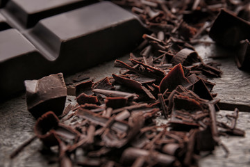 Chocolate curls on wooden table, closeup