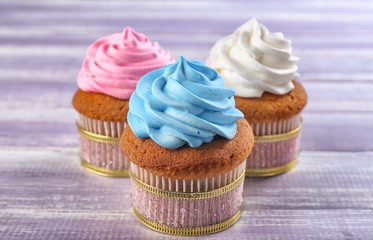Tasty cupcakes on wooden background. Mother's Day celebration