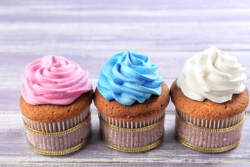 Tasty cupcakes on wooden background. Mother's Day celebration