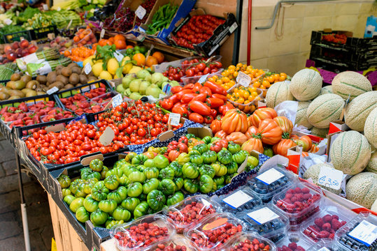 Food market in the center of Bologna, Italy. Fresh vegetables and fruits are on display. Healthy eating. Selective focus.