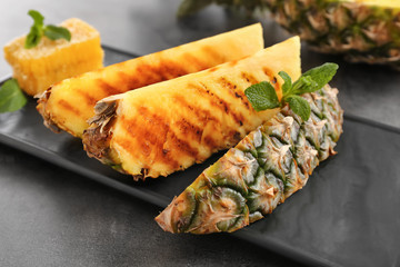 Grilled pineapple slices on table, closeup
