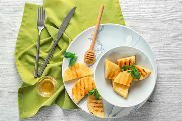 Composition with tasty grilled pineapple on white wooden table, top view