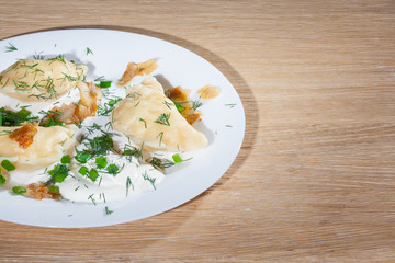 Ukrainian vareniki served on the Faror plate with onions, sour cream and dill