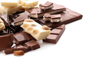 Different chocolate pieces on white background