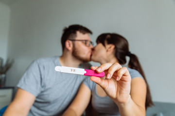 happy couple looking on pregnancy test