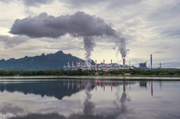 Industrial power plant with smokestack near the river