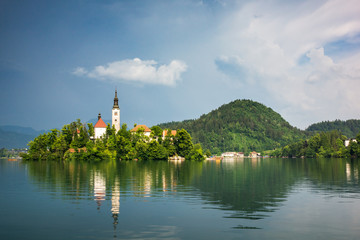 Fototapeta na wymiar Church on the island on Lake Bled at sunny day, Slovenia