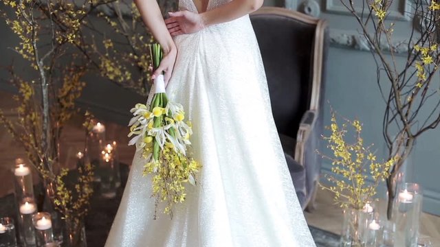 Beautiful bride is holding a wedding colorful bouquet