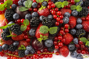 Ripe blackberries, blackberries, strawberries, red currants, peaches and plums. Mix berries and fruits. Top view. Background berries. 