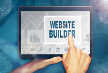 A hand selecting a Website Builder business concept on a computer tablet screen with a colorful...
