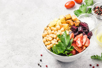 Roasted root vegetables and chickpeas buddha bowl. Selective focus, space for text.