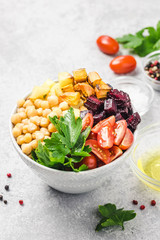 Roasted root vegetables and chickpeas buddha bowl. Selective focus, space for text.