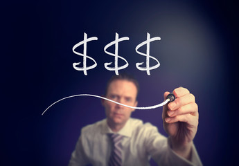 A businessman writing a Dollars concept with a white pen on a clear screen.
