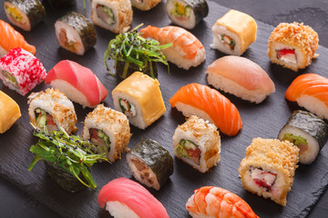 Set of sushi maki and rolls on gray background © Prostock-studio