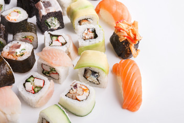 Set of sushi, maki and rolls on white