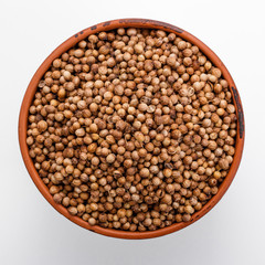 fragrant coriander seeds on a white background