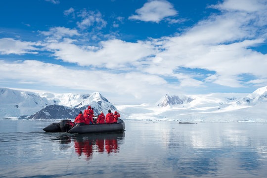 Fototapeta Inflatable boat full of tourists, watching for whales and seals, Antarctic Peninsula, Antarctica