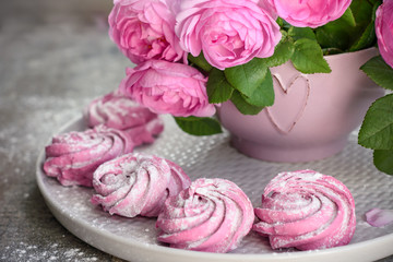 Pink berry marshmallows and a bouquet of roses.
