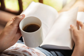 Happy Woman sitting and holding cup of hot coffee.
