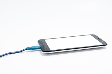 Smartphone with charger cable isolated on white background.