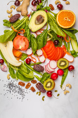 Raw fresh vegetables, fruits, berries, nuts on a white background. Healthy food background, top view. Go vegan concept.