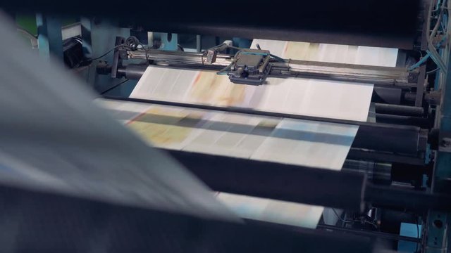 Colorful sheets on a conveyor, close up.
