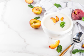 Sweet creamy peach soup, vegan summer food, white marble background copy space