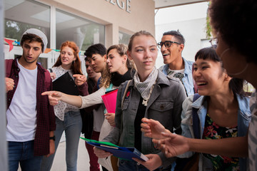 College students looking at information posted on campus