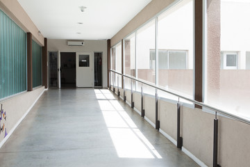 Sunlight shining through windows in empty corridor