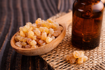 frankincense essential oil on a wooden background