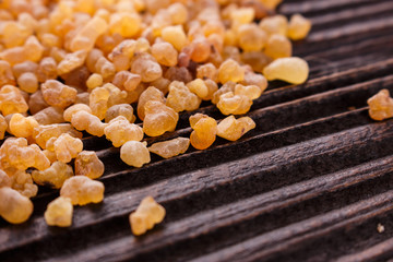 frankincense essential oil on a wooden background