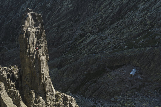 Aerial view of climber ascending a granite tower at last hours of the day