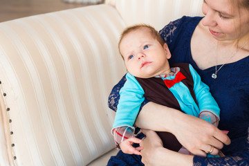 Portrait of young mother with cute baby at home