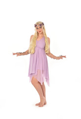 full length portrait of pretty blonde girl wearing purple fairy dress. standing pose, isolated on white studio background.