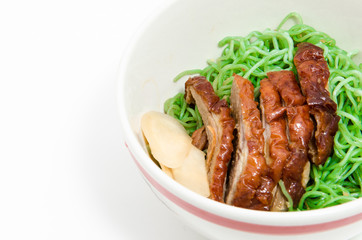 Green noodles with duck in bowl.