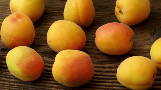 Ripe apricots on the wooden background