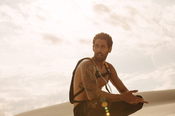 Male athlete taking a break from workout in desert