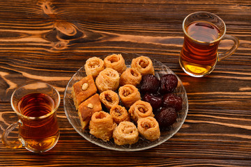 Tea with rahat  and dried fruits on a wooden table