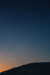 a beautiful view of the starry sky, and mountains, the sky full of stars, vertical photo