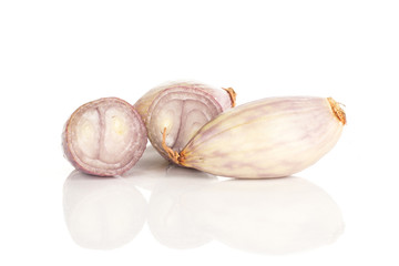 Peeled shallot one whole and two halves isolated on white background.
