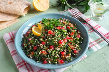 A plate of tabbouleh salad, close-up. Traditional Arabic food.