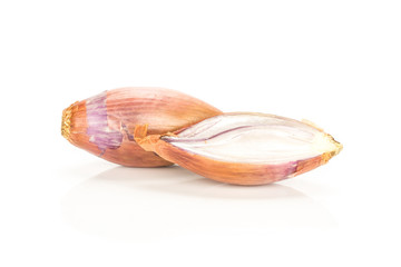 One golden shallot with one section half isolated on white background.