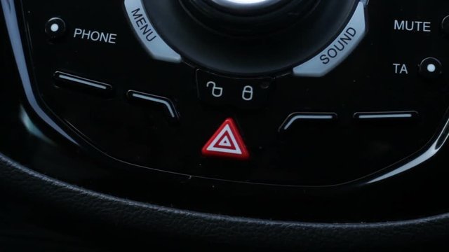 Cautious lady presses emergensy light button to save her children from accident.