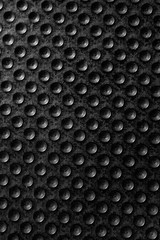 Black dotted texturised technological seamless fabric or surface closeup