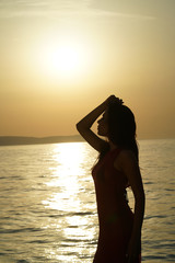woman silhouette by sunset