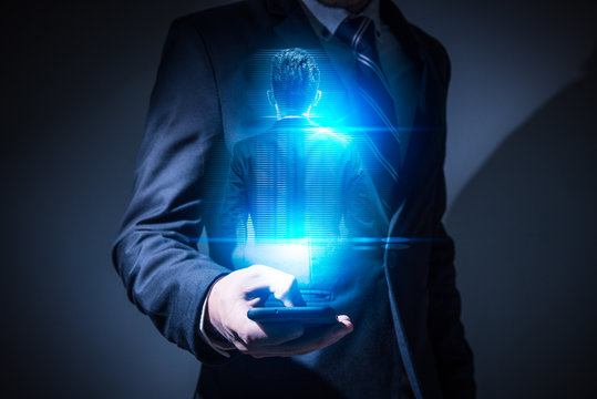 The abstract image of the businessman hold the man's virtual hologram on smartphone for communication. the concept of communication network, futuristic, internet of things and future life.