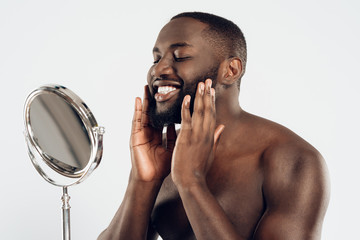 African American man uses moisturizing lotion